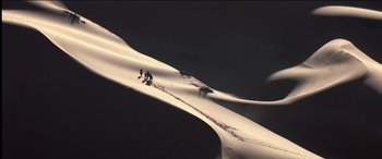 Movie still from “The Four Feathers” (2002), directed by Shekhar Kapur – A group of people standing on top of a snow covered slope; Extreme Wide shot, High angle