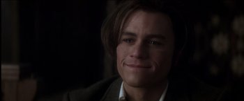 Movie still from “The Four Feathers” (2002), directed by Shekhar Kapur – A person wearing a suit and smiling; Close Up shot, High angle