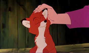Movie still from “The Fox and the Hound” (1981), directed by Richard Rich – A hand touching a fox's head in a scene from the fox and the hound movie; Close Up shot, Over the shoulder angle