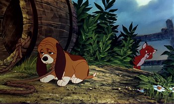 Movie still from “The Fox and the Hound” (1981), directed by Richard Rich – A dog sitting on the ground next to a tree; Wide shot, High angle