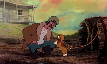 Movie still from “The Fox and the Hound” (1981), directed by Richard Rich – A man kneeling down next to a brown dog; Medium shot, Low angle