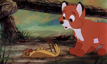 Movie still from “The Fox and the Hound” (1981), directed by Richard Rich – An animated fox sitting next to an animal laying on the ground; Medium shot, High angle