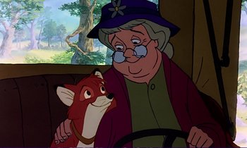 Movie still from “The Fox and the Hound” (1981), directed by Richard Rich – An old woman sitting next to a red fox; Close Up shot, Over the shoulder angle