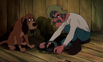 Movie still from “The Fox and the Hound” (1981), directed by Richard Rich – A man and a dog are sitting on the floor; Medium shot, High angle