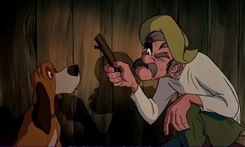 Movie still from “The Fox and the Hound” (1981), directed by Richard Rich – An old man is holding a gun in front of a dog; Close Up shot, Over the shoulder angle