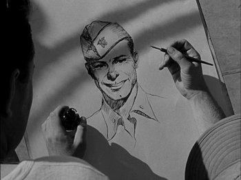 Movie still from “The Frogmen” (1951), directed by Lloyd Bacon – A man is drawing a picture of a soldier; Close Up shot, High angle