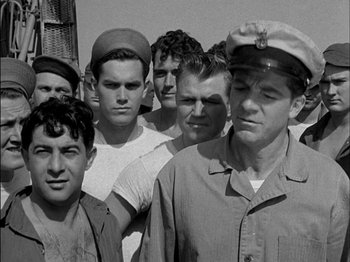 Movie still from “The Frogmen” (1951), directed by Lloyd Bacon – A black and white photo of a group of men; Medium shot, Low angle