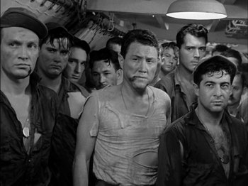 Movie still from “The Frogmen” (1951), directed by Lloyd Bacon – A black and white photo of a group of men; Medium shot, High angle