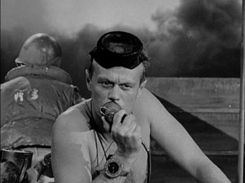 Movie still from “The Frogmen” (1951), directed by Lloyd Bacon – An old photo of a man eating a sandwich; Close Up shot, Low angle