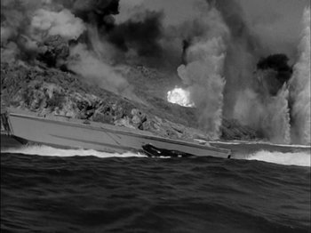 Movie still from “The Frogmen” (1951), directed by Lloyd Bacon – Black and white photograph of a boat in the ocean; Extreme Wide shot, High angle