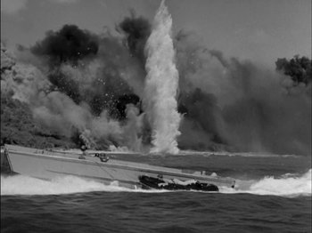 Movie still from “The Frogmen” (1951), directed by Lloyd Bacon – An old photo of a boat in the water; Extreme Wide shot, High angle