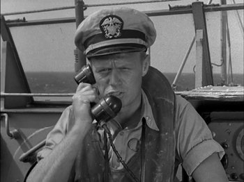 Movie still from “The Frogmen” (1951), directed by Lloyd Bacon – An old photo of a man talking on a phone; Close Up shot, High angle