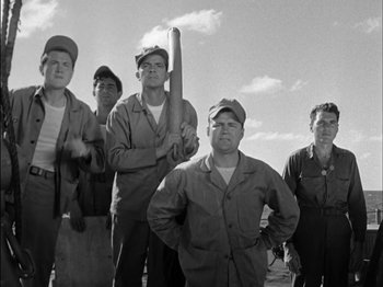 Movie still from “The Frogmen” (1951), directed by Lloyd Bacon – A black and white photo of a group of workers; Medium shot, Low angle