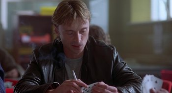 Movie still from “The Full Monty” (1997), directed by Peter Cattaneo – A man sitting at a table smoking a cigarette; Close Up shot, Over the shoulder angle