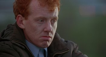 Movie still from “The Full Monty” (1997), directed by Peter Cattaneo – A person wearing a jacket and tie; Close Up shot, Low angle