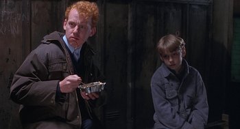 Movie still from “The Full Monty” (1997), directed by Peter Cattaneo – A man and a boy sitting next to each other; Medium shot, Over the shoulder angle