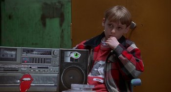 Movie still from “The Full Monty” (1997), directed by Peter Cattaneo – A young boy sitting in front of an old radio; Close Up shot, Over the shoulder angle