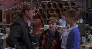 Movie still from “The Full Monty” (1997), directed by Peter Cattaneo – A group of people standing next to each other in a room; Medium shot, Over the shoulder angle