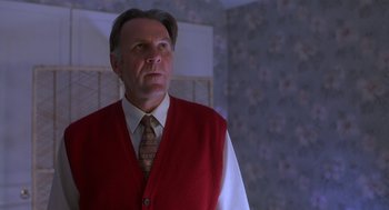 Movie still from “The Full Monty” (1997), directed by Peter Cattaneo – A man wearing a red vest and a white shirt; Medium shot, Low angle