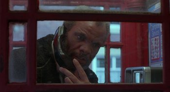 Movie still from “The Full Monty” (1997), directed by Peter Cattaneo – A man with a beard is talking on a phone; Close Up shot, Low angle