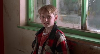 Movie still from “The Full Monty” (1997), directed by Peter Cattaneo – A boy in a red and black plaid jacket; Close Up shot, Over the shoulder angle