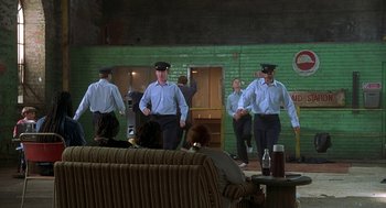 Movie still from “The Full Monty” (1997), directed by Peter Cattaneo – A group of men are dancing in a living room; Wide shot, Low angle