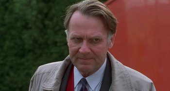 Movie still from “The Full Monty” (1997), directed by Peter Cattaneo – A person wearing a suit and tie; Close Up shot, Low angle