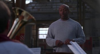 Movie still from “The Full Monty” (1997), directed by Peter Cattaneo – A man standing in front of another man; Medium shot, Low angle