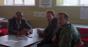 Movie still from “The Full Monty” (1997), directed by Peter Cattaneo – A group of men sitting at a table with cards; Medium shot, High angle