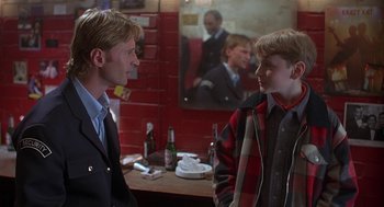 Movie still from “The Full Monty” (1997), directed by Peter Cattaneo – Two young men talking in front of a mirror; Medium shot, Over the shoulder angle