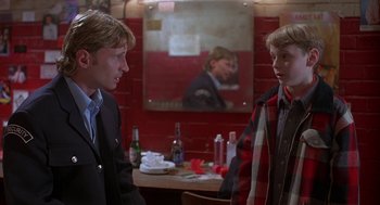 Movie still from “The Full Monty” (1997), directed by Peter Cattaneo – Two young men standing next to each other in front of a mirror; Medium shot, Over the shoulder angle