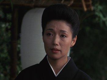 A woman in a black kimono looking at the camera