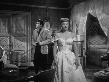 Movie still from “The Furies” (1950), directed by Anthony Mann – A man and a woman standing in front of a mirror; Medium shot, Low angle