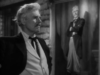 Movie still from “The Furies” (1950), directed by Anthony Mann – An older man standing next to an old man; Medium shot, Over the shoulder angle