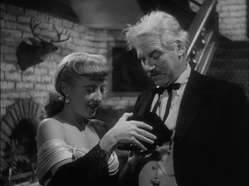 Movie still from “The Furies” (1950), directed by Anthony Mann – An older man and a young woman looking at something in their hands; Close Up shot, High angle