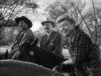 Movie still from “The Furies” (1950), directed by Anthony Mann – A black and white photo of a man , a woman , and a horse; Medium shot, Low angle