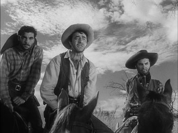 Movie still from “The Furies” (1950), directed by Anthony Mann – A group of men on horses in a field; Medium shot, Low angle