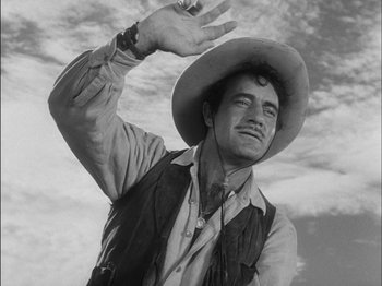 Movie still from “The Furies” (1950), directed by Anthony Mann – A man wearing a cowboy hat and a vest; Medium shot, Low angle