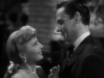 Movie still from “The Furies” (1950), directed by Anthony Mann – A man and a woman are smiling at each other; Close Up shot, High angle