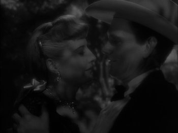 Movie still from “The Furies” (1950), directed by Anthony Mann – A man and a woman kissing in a black and white photo; Close Up shot, High angle