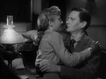 Movie still from “The Furies” (1950), directed by Anthony Mann – A man and a woman hugging in a room; Medium shot, Over the shoulder angle