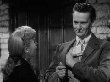 Movie still from “The Furies” (1950), directed by Anthony Mann – A man in a suit and a woman in a black dress; Medium shot, Over the shoulder angle