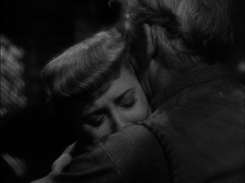 Movie still from “The Furies” (1950), directed by Anthony Mann – An old photo of a man and a woman hugging; Close Up shot, Over the shoulder angle