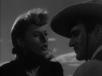 Movie still from “The Furies” (1950), directed by Anthony Mann – A man and a woman are looking at one another; Close Up shot, Low angle