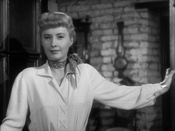 Movie still from “The Furies” (1950), directed by Anthony Mann – A black and white photo of a woman with a bird on her shoulder; Close Up shot, Low angle