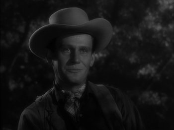 Movie still from “The Furies” (1950), directed by Anthony Mann – A black and white photo of a man wearing a cowboy hat; Close Up shot, Over the shoulder angle