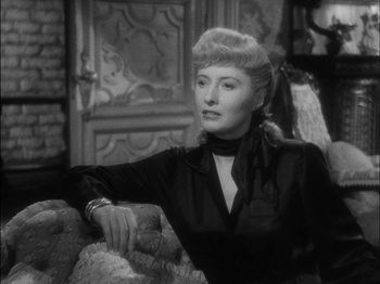 Movie still from “The Furies” (1950), directed by Anthony Mann – An old photo of a woman sitting on a couch; Close Up shot, Over the shoulder angle