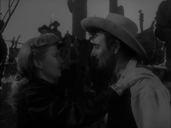 Movie still from “The Furies” (1950), directed by Anthony Mann – A man and a woman in a black and white photo; Medium shot, Over the shoulder angle