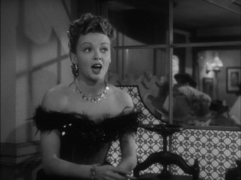 Movie still from “The Furies” (1950), directed by Anthony Mann – A black and white photo of a woman in a black dress; Close Up shot, Over the shoulder angle