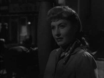 Movie still from “The Furies” (1950), directed by Anthony Mann – A black - and - white photo of a woman with a ponytail; Close Up shot, Over the shoulder angle